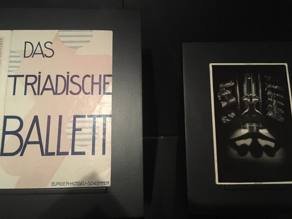 Poster for and performance photo from Oskar Schlemmer’s “The Triadic Ballet”. Photo courtesy of the Getty Institute.