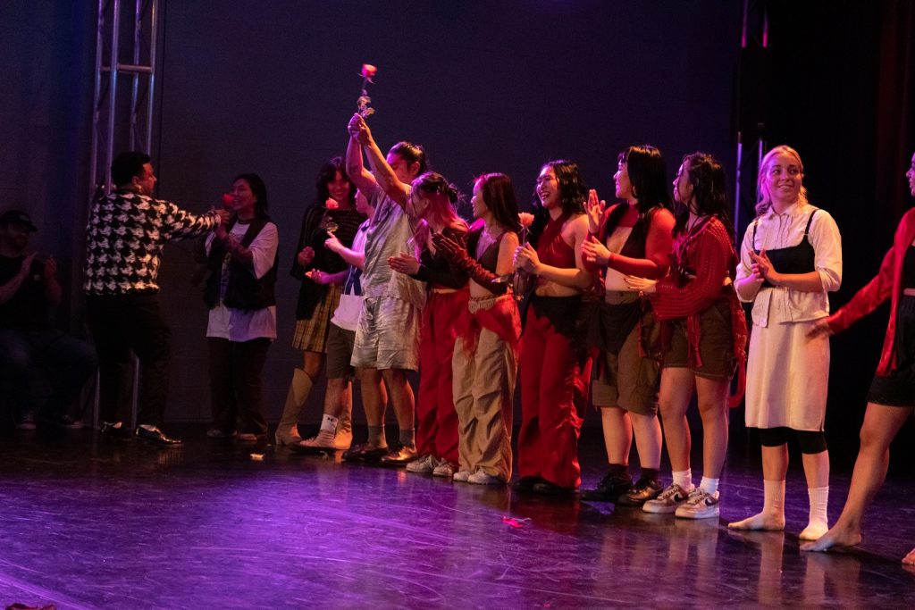 VOICES - Curtain Call - L-R Derrick Paris, handing a rose to Jane from above, Sydney Schafer in the black long sleeve and boots, JM Rodriguez, Ryan Ruiz, Teresa Declines, and Casey Shea - Photo by Victoria Roman
