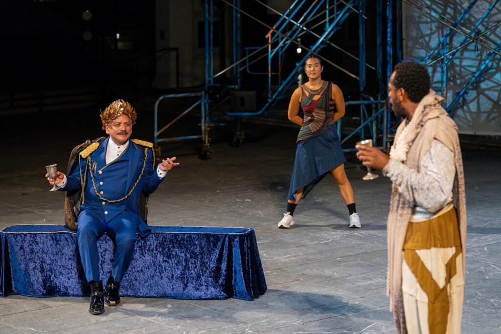 Jesse J. Perez as Priam and Eric Berryman as Memnon in foreground, and Holly Hwang Belshaw as Chorus in background. Photo: © 2024 J. Paul Getty Trust.