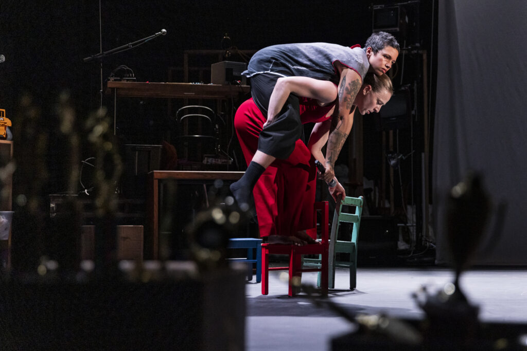 Jenn Freeman carrying Holland Andrews in "Is It Thursday Yet?" - Photo by Matthew Murphy.