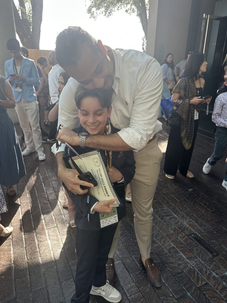 Spencer Collinss gets a congratulatory hug from Westside’s Associate Executive Director Adrian Blake Mitchell after receiving his award - Photo courtesy of Amelia Collins.