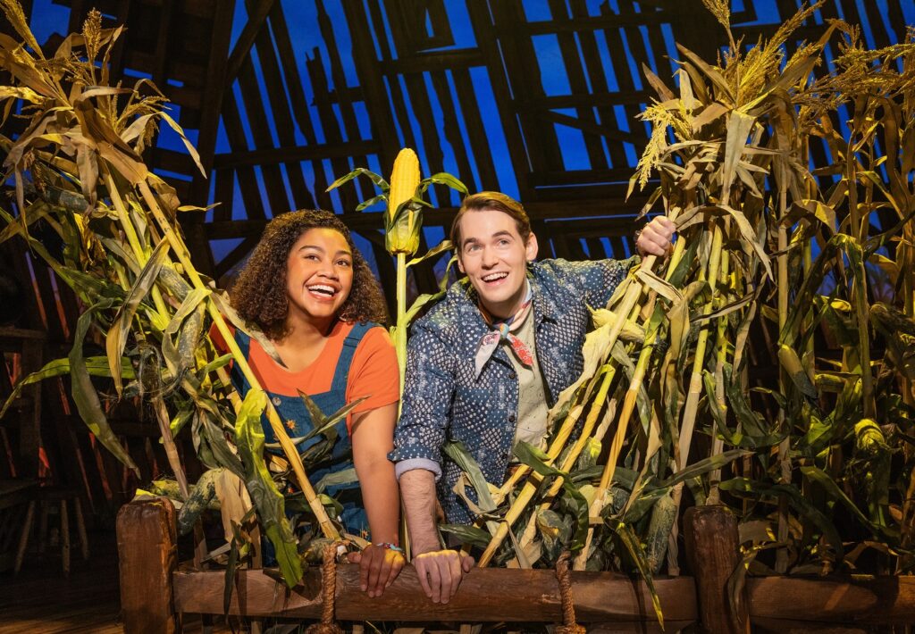 Maya Lagerstam (Storyteller 1) and Tyler Joseph Ellis (Storyteller 2) in The North American Tour of SHUCKED - Photo by Matthew Murphy and Evan Zimmerman.