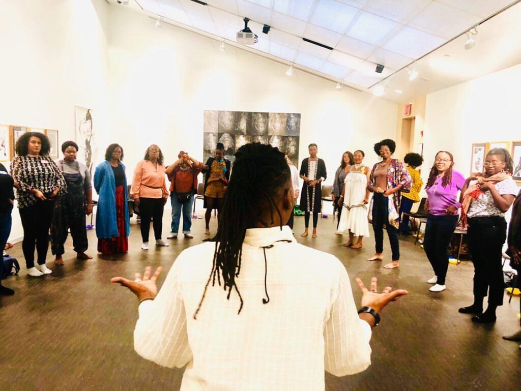 Sage Ni'Ja Whitson speaking to group in an art gallery - Photo by Dia Bui.