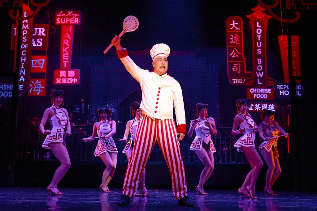 (Center) Marc Oka and (L-R) Esther Lee, Gemma Pedersen, Ai Toyoshima, Sally Hong, Hillary Tang, and Emma Park in Rogers and Hammerstein's FLOWER DRUM SONG - Photo by Mike Palma.